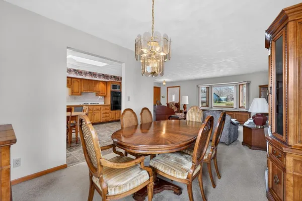 a dining room with furniture and a flat screen tv