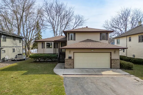 a front view of a house with a yard garage and outdoor seating