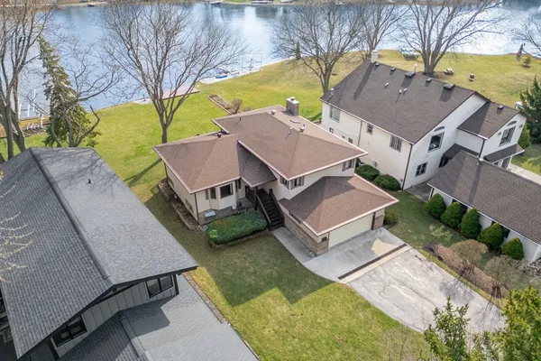 an aerial view of a house with a lake view