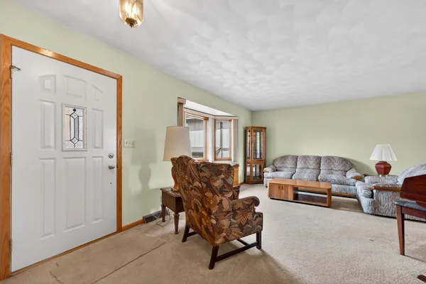 a living room with furniture and a piano