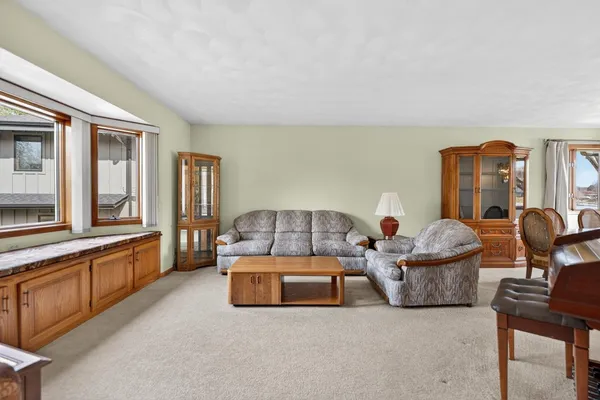 a dining room with furniture window and wooden floor