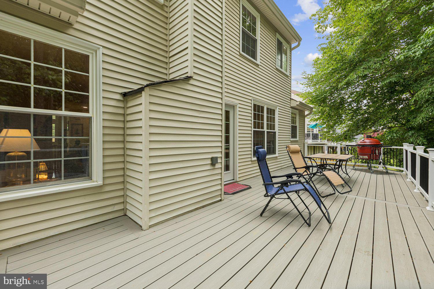 3707 Turn Back Trail Triangle, VA 22172 - Photo 24 of 55 a view of a roof deck with table and chairs a barbeque with wooden floor and fence