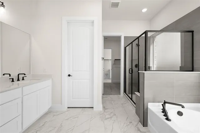 a bathroom with a tub sink and mirror