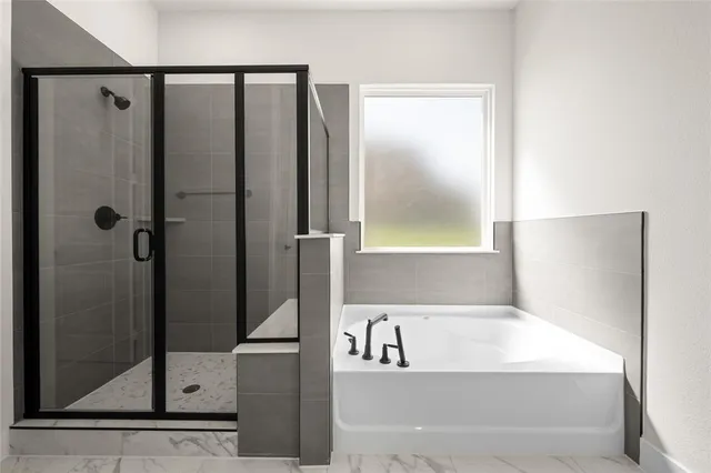 a bathroom with a bathtub and a shower