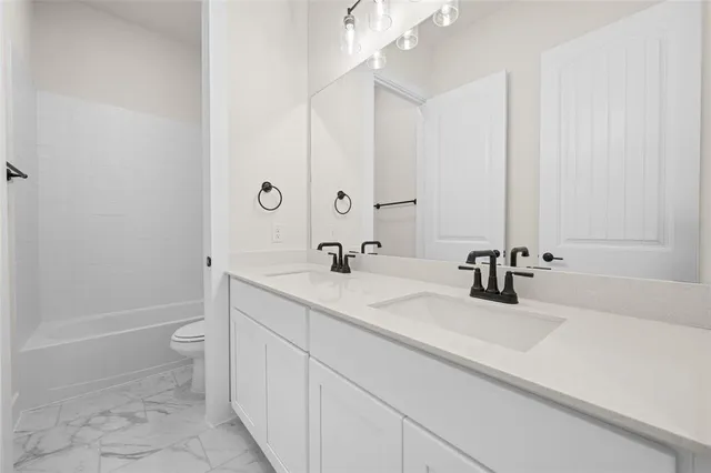 a bathroom with a sink a toilet and a tub