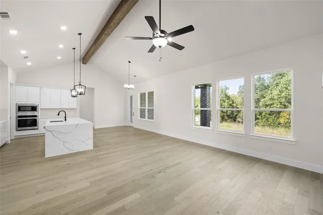 an open kitchen with furniture and a large window