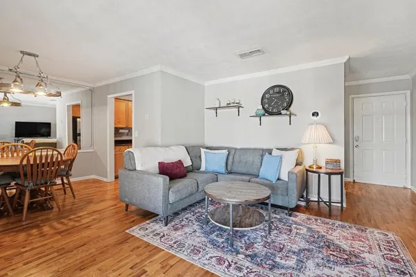 a living room with furniture a rug and a table