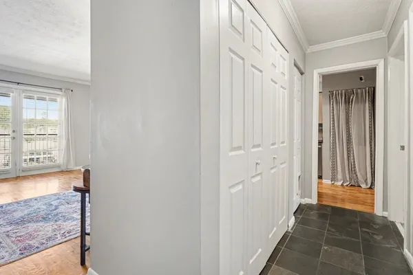 a view of a hallway with wooden floor and staircase