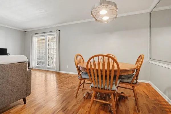 a view of a dining room with furniture and wooden floor