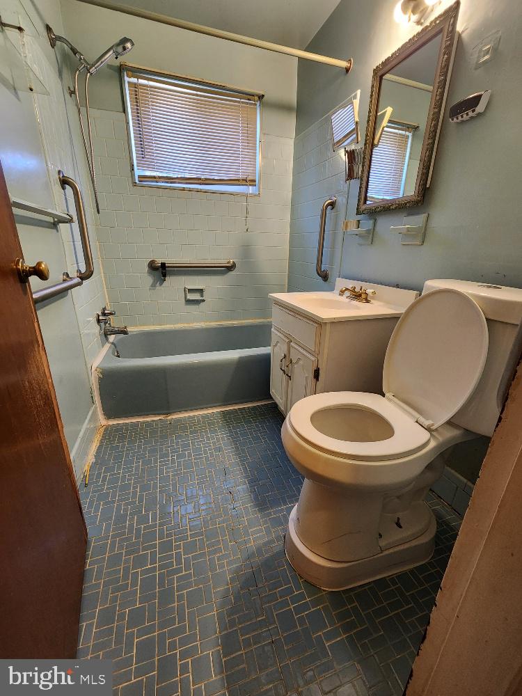 1108 Chaplin Street Southeast Washington, DC 20019 - Photo 14 of 35 a bathroom with a toilet a sink and a mirror