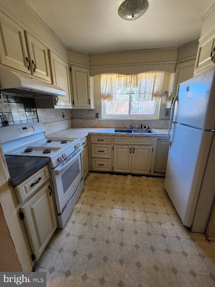 1108 Chaplin Street Southeast Washington, DC 20019 - Photo 18 of 35 a kitchen with stainless steel appliances granite countertop a sink stove and refrigerator