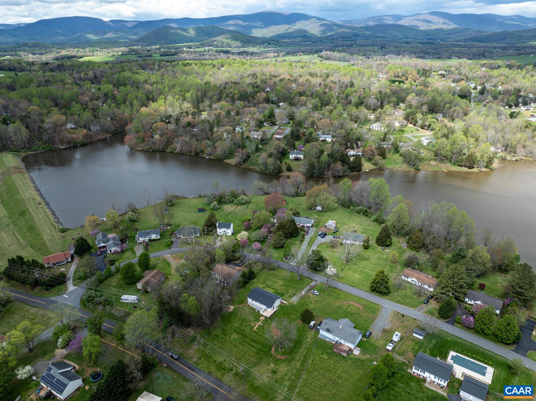100 East Daffodil Road Ruckersville, VA 22968 - Photo 36 of 41 a view of a lake with a mountain and a yard