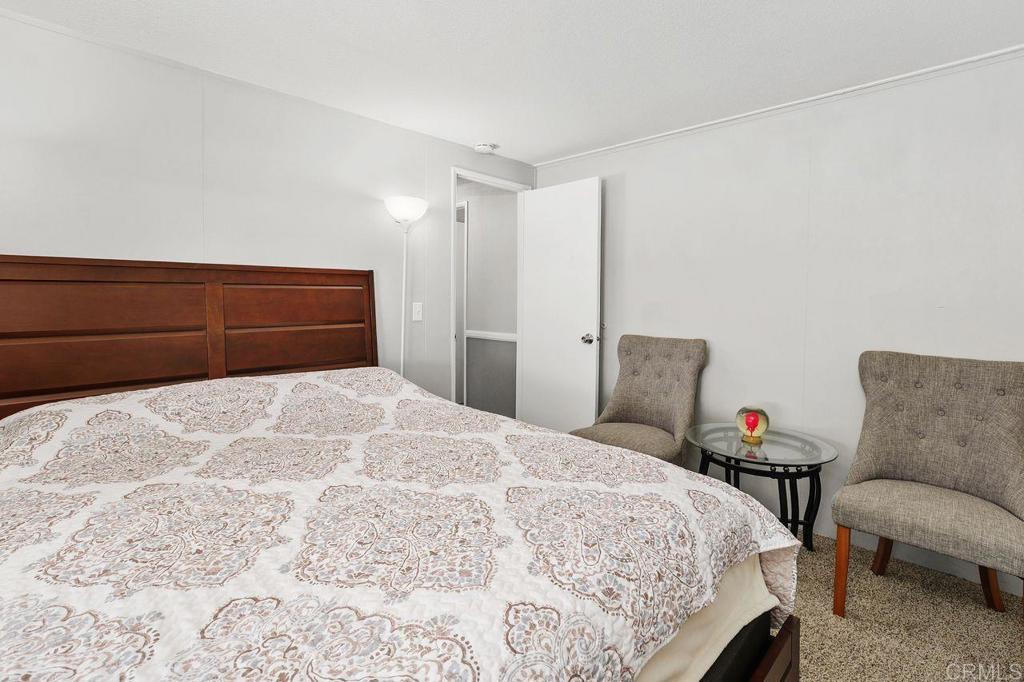 530 West Devonshire Avenue, Unit 84 Hemet, CA 92543 - Photo 26 of 36 a bedroom with a bed and a couch