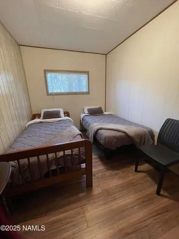 a bedroom with a bed and a chair
