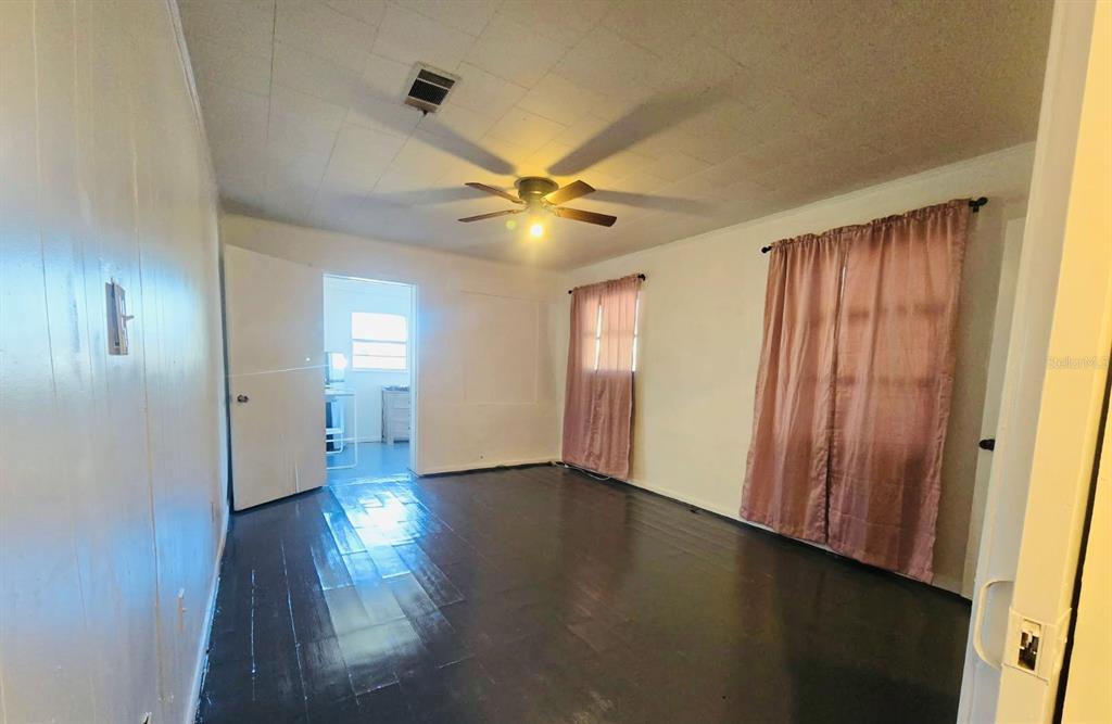 8010 Southeast Us Highway, Unit 5B Hawthorne, FL 32640 - Photo 4 of 7 an empty room with wooden floor and a window
