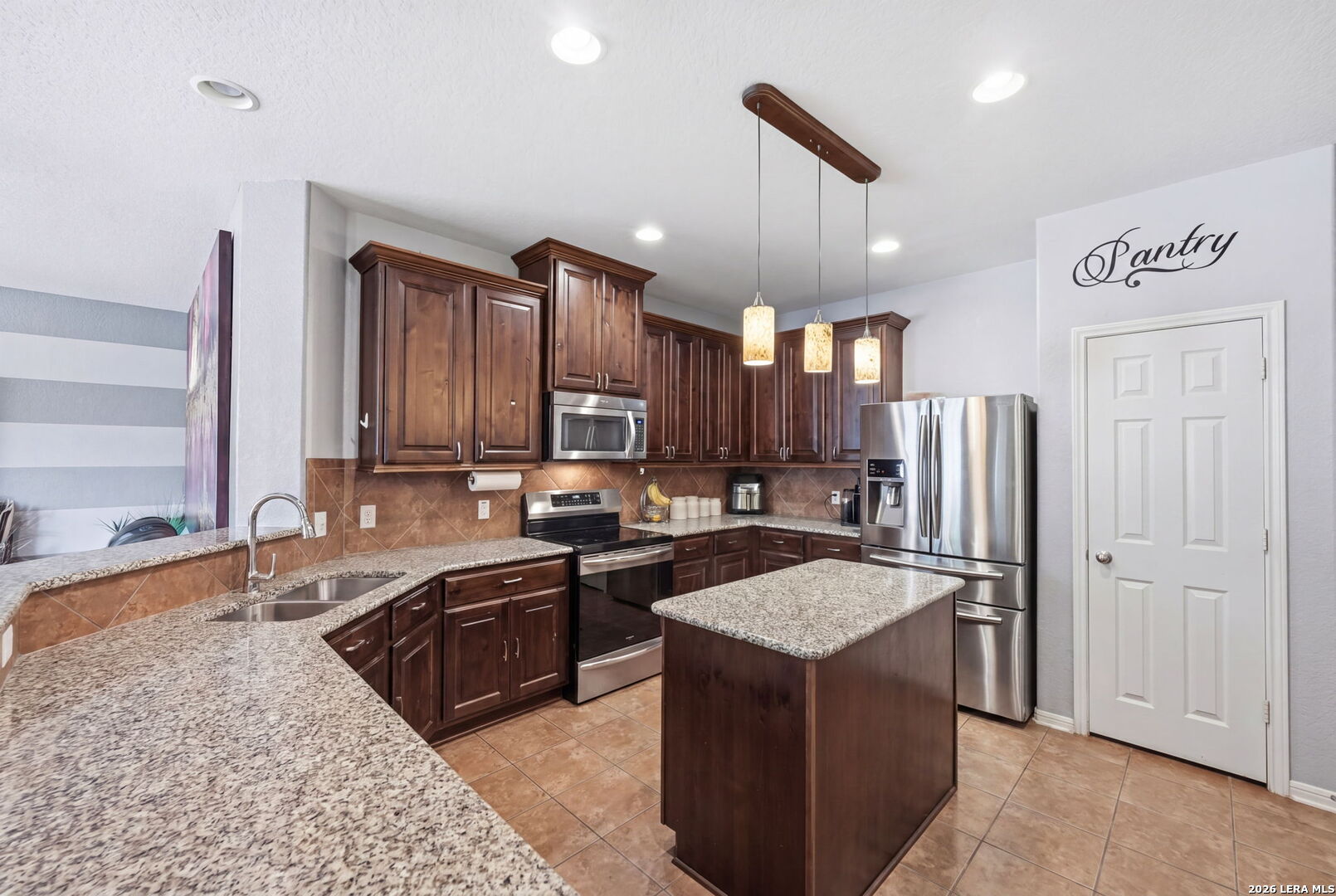 516 Brook Shadow Cibolo, TX 78108 - Photo 12 of 39 a kitchen with stainless steel appliances granite countertop a sink stove and refrigerator