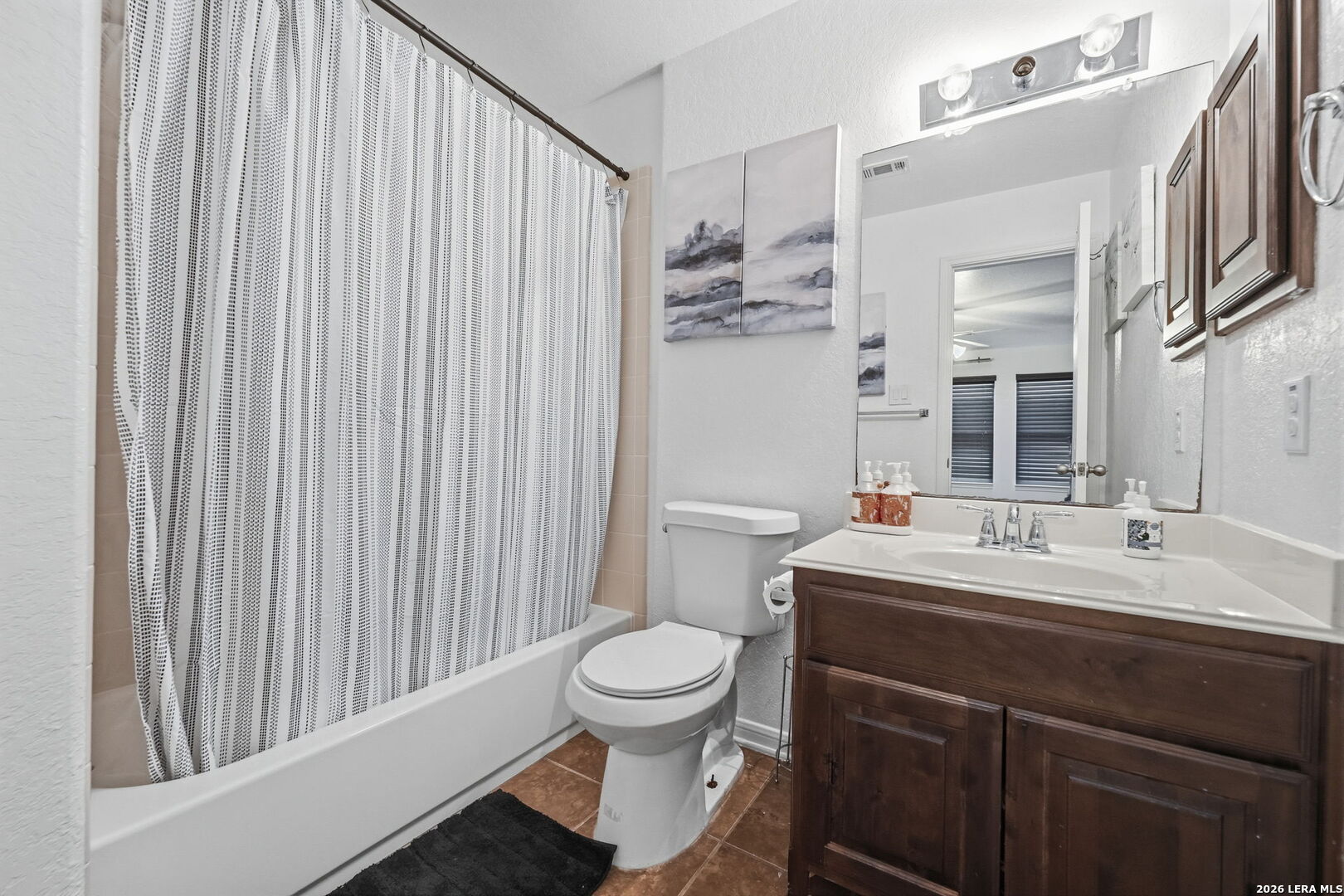 516 Brook Shadow Cibolo, TX 78108 - Photo 32 of 39 a bathroom with a sink a toilet and a mirror