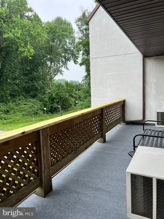 a view of a balcony with wooden fence