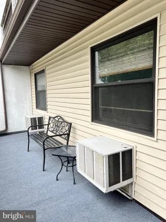 a view of a house with a chairs in a patio