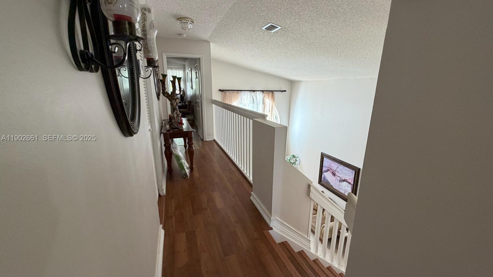 14713 Southwest 155th Place Miami, FL 33196 - Photo 11 of 23 a view of a hallway with wooden floor