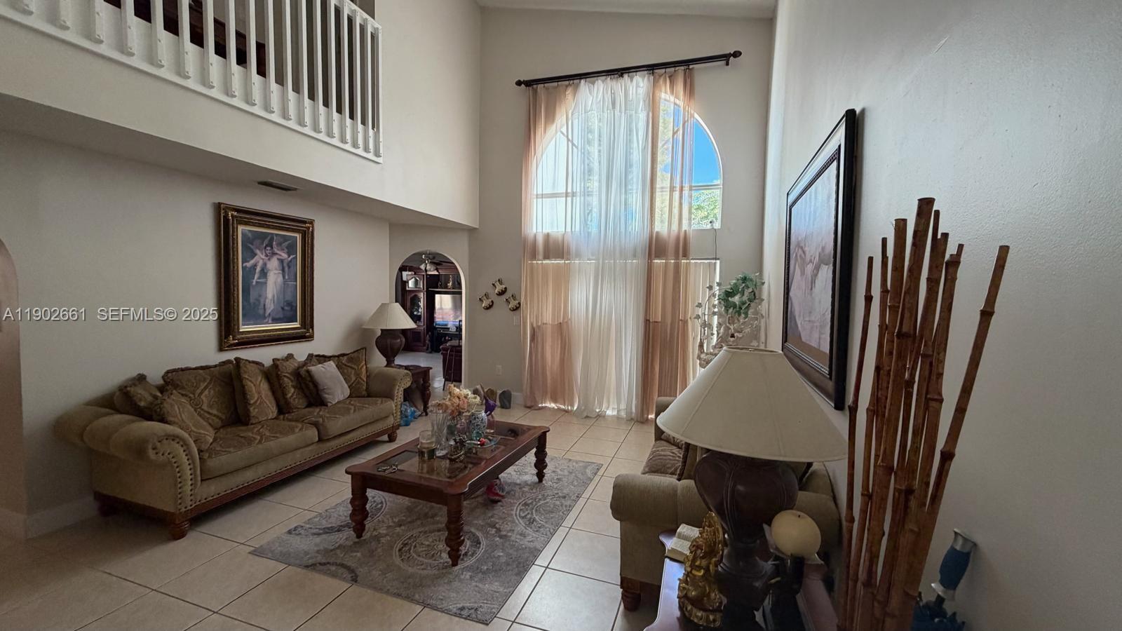 14713 Southwest 155th Place Miami, FL 33196 - Photo 2 of 23 a living room with furniture and a window