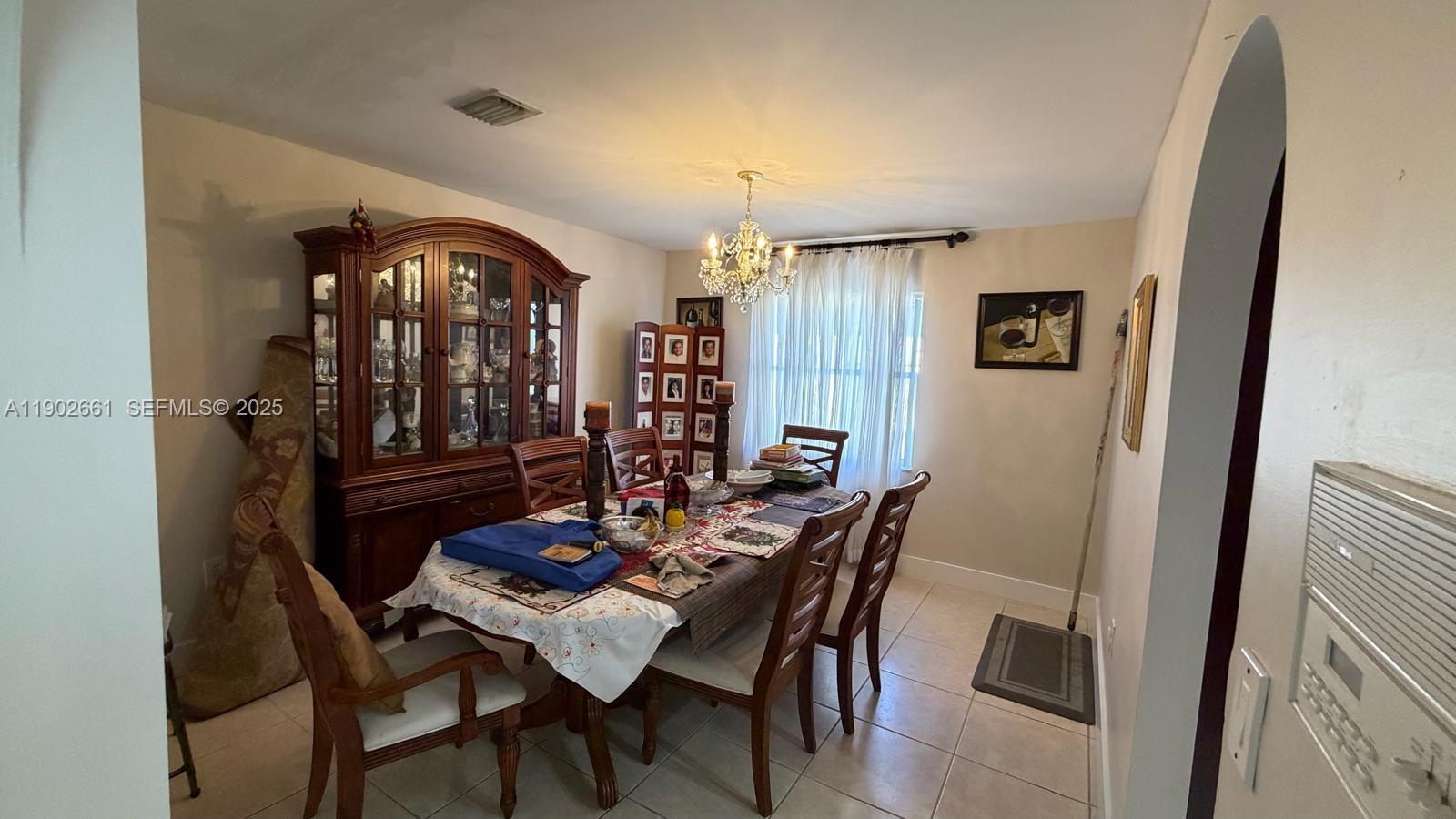 14713 Southwest 155th Place Miami, FL 33196 - Photo 3 of 23 a view of a dining room with furniture and window