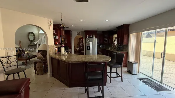 a kitchen with a dining table and chairs