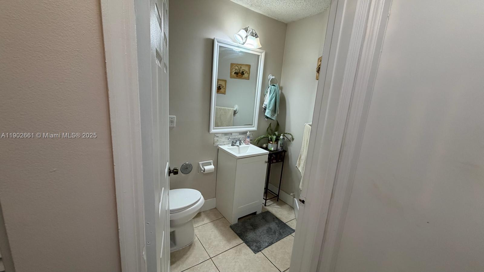 14713 Southwest 155th Place Miami, FL 33196 - Photo 9 of 23 a bathroom with a toilet and a sink