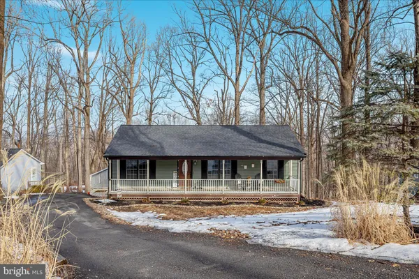 a house that has a tree in front of it