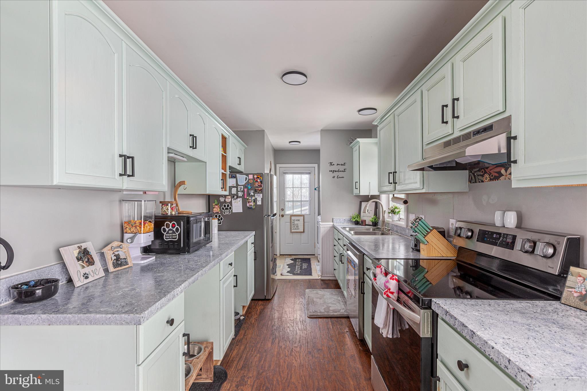 67 Pocahontas Road Front Royal, VA 22630 - Photo 13 of 49 a kitchen with stainless steel appliances granite countertop a stove top oven a sink dishwasher and cabinets with wooden floor