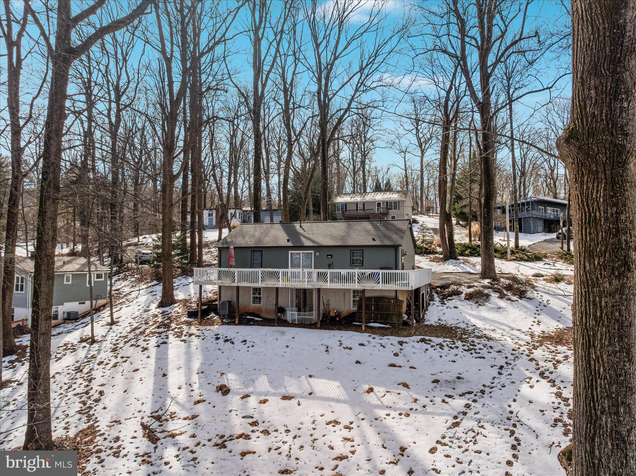 67 Pocahontas Road Front Royal, VA 22630 - Photo 44 of 49 a front view of a house with a yard covered with snow and trees