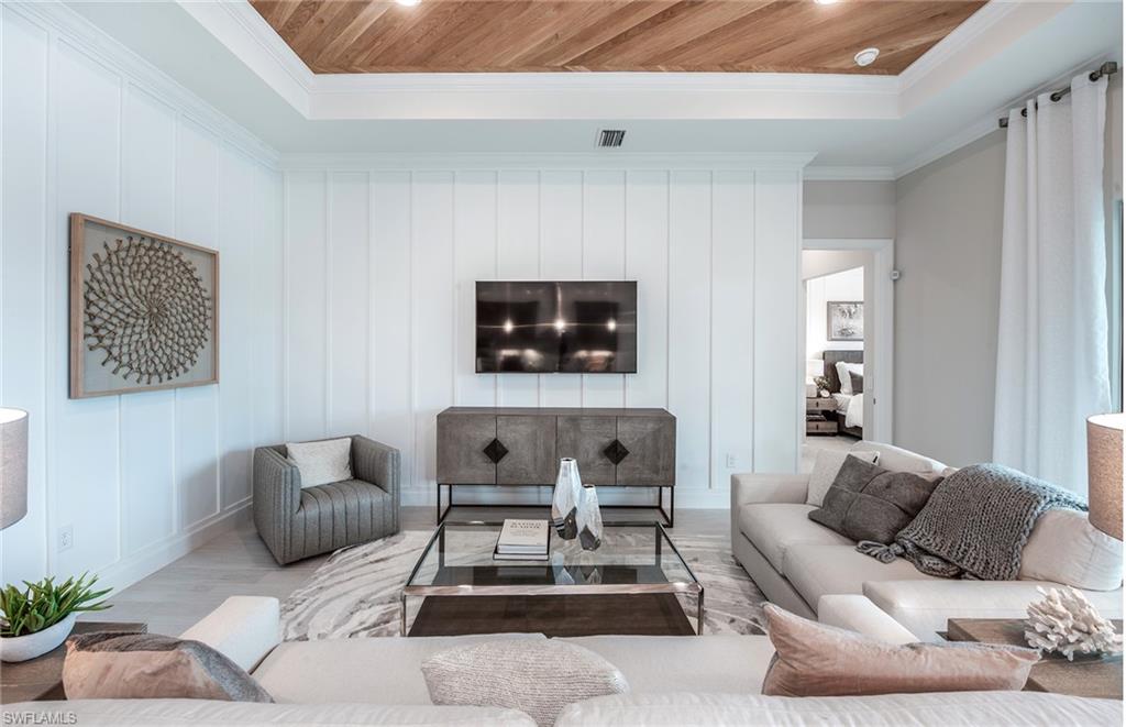 2126 Yellowfin Circle Naples, FL 34114 - Photo 11 of 29 a living room with furniture and a flat screen tv