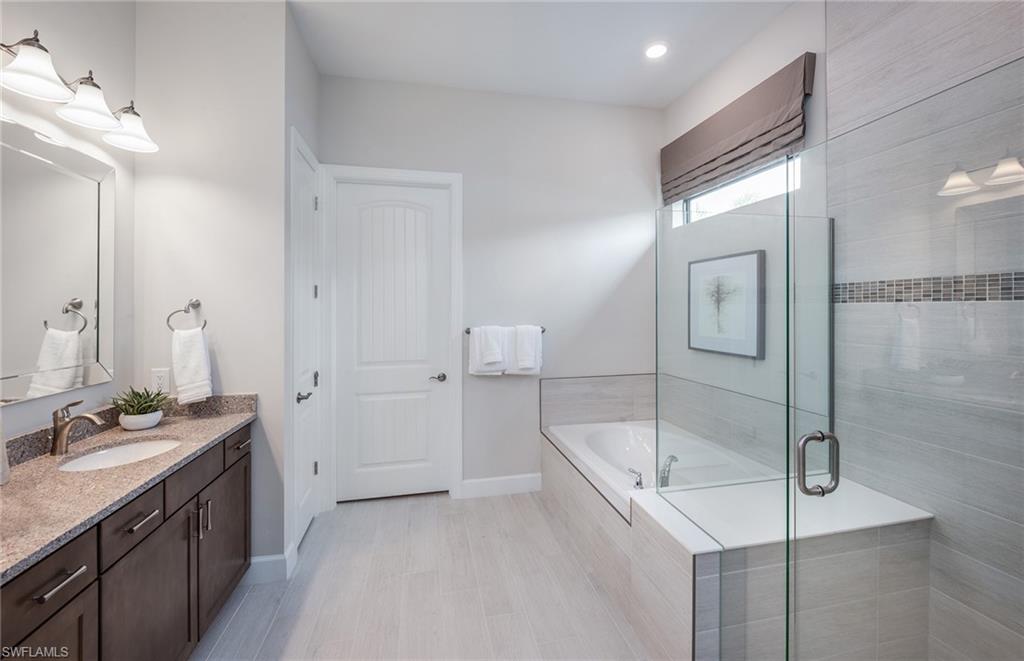 2126 Yellowfin Circle Naples, FL 34114 - Photo 19 of 29 a bathroom with a sink and mirror
