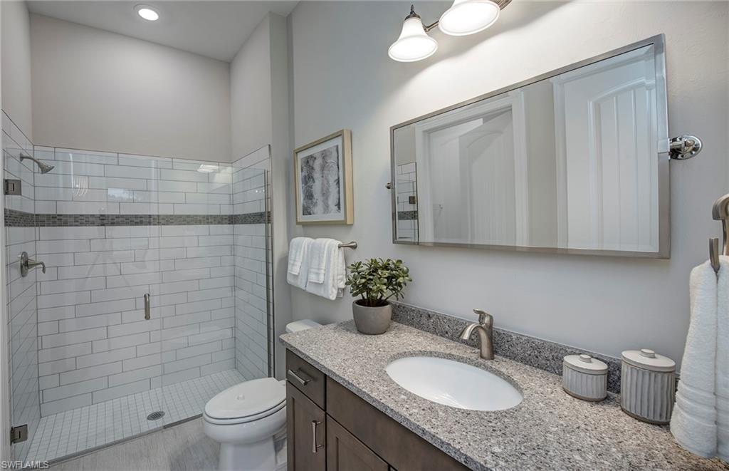 2126 Yellowfin Circle Naples, FL 34114 - Photo 21 of 29 a bathroom with a granite countertop sink toilet and shower