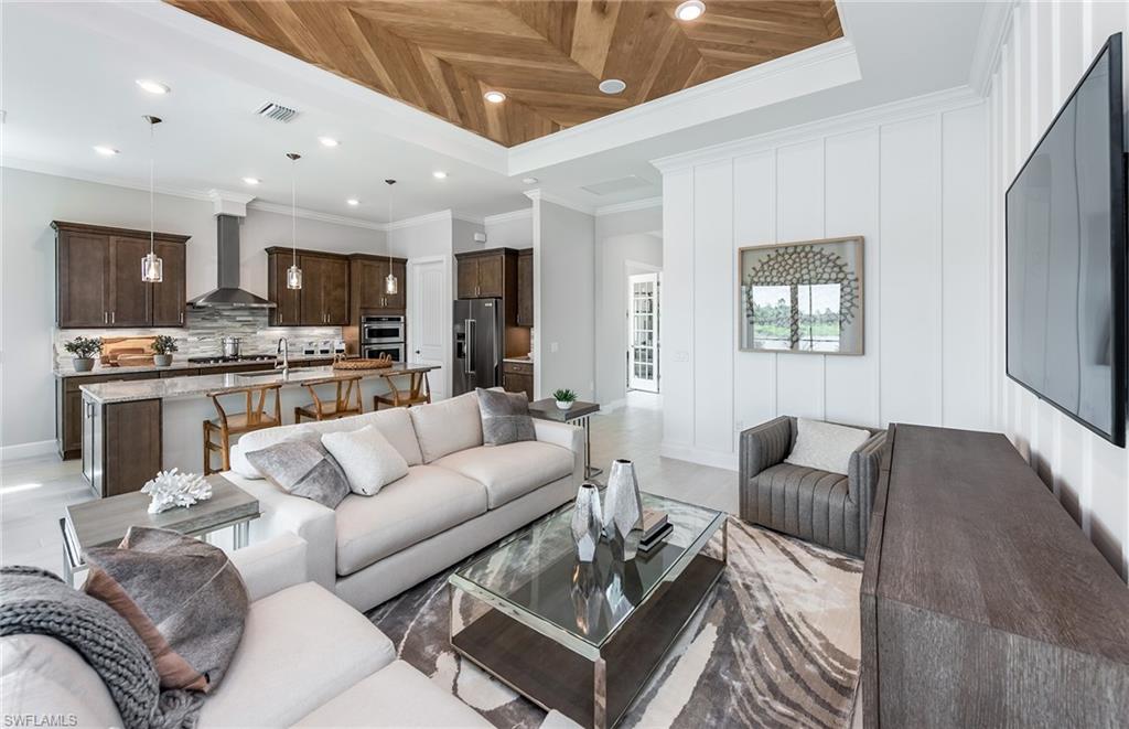 2126 Yellowfin Circle Naples, FL 34114 - Photo 9 of 29 a living room with furniture kitchen and a wooden floor