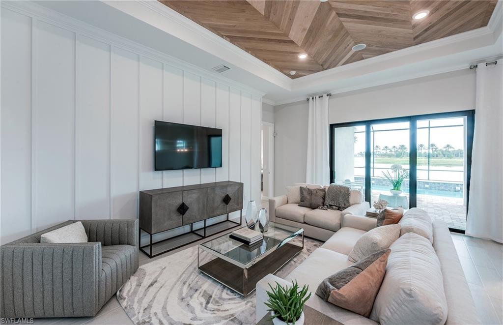 2126 Yellowfin Circle Naples, FL 34114 - Photo 10 of 29 a living room with furniture and a flat screen tv