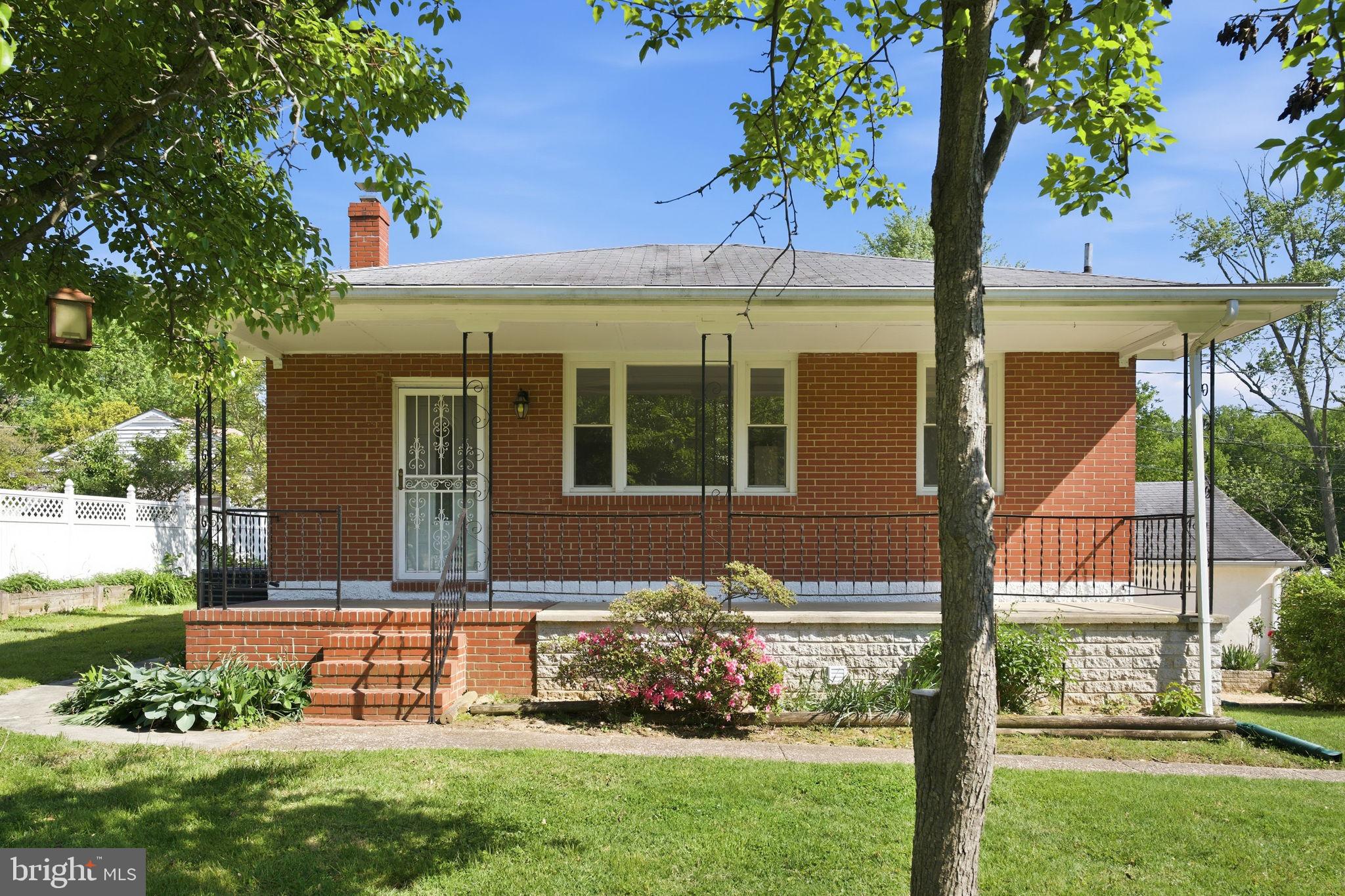 2301 Bayside Drive Baltimore, MD 21221 - Photo 1 of 35 a front view of a house with a garden