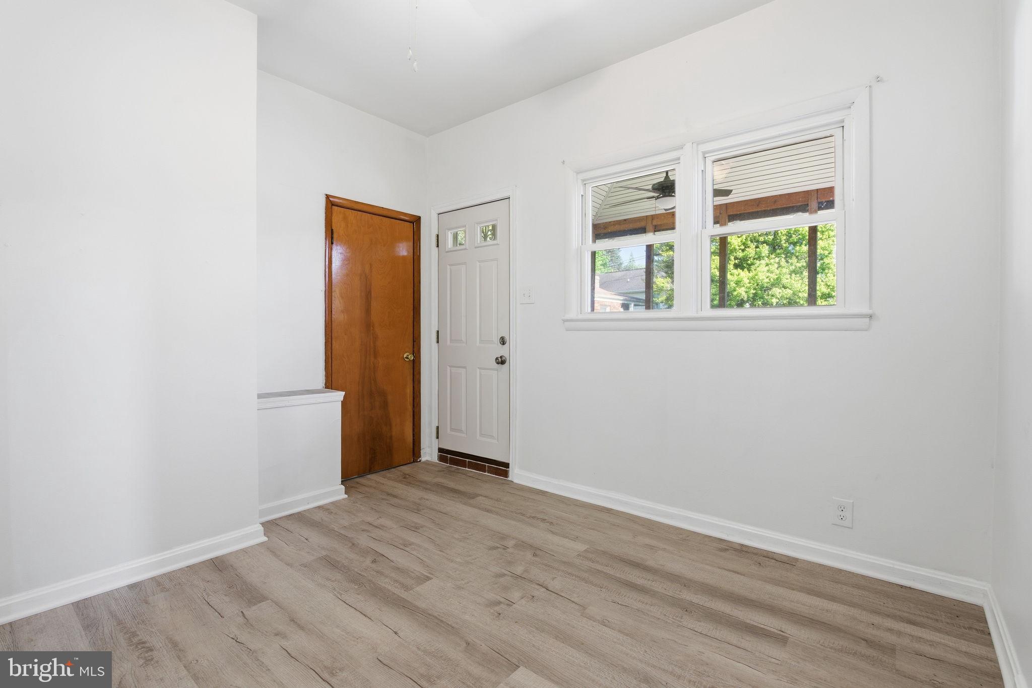 2301 Bayside Drive Baltimore, MD 21221 - Photo 13 of 35 an empty room with wooden floor and a window