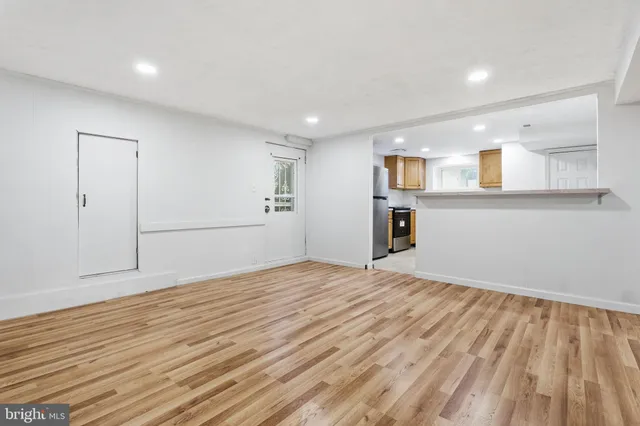 a view of a kitchen with a sink and a refrigerator