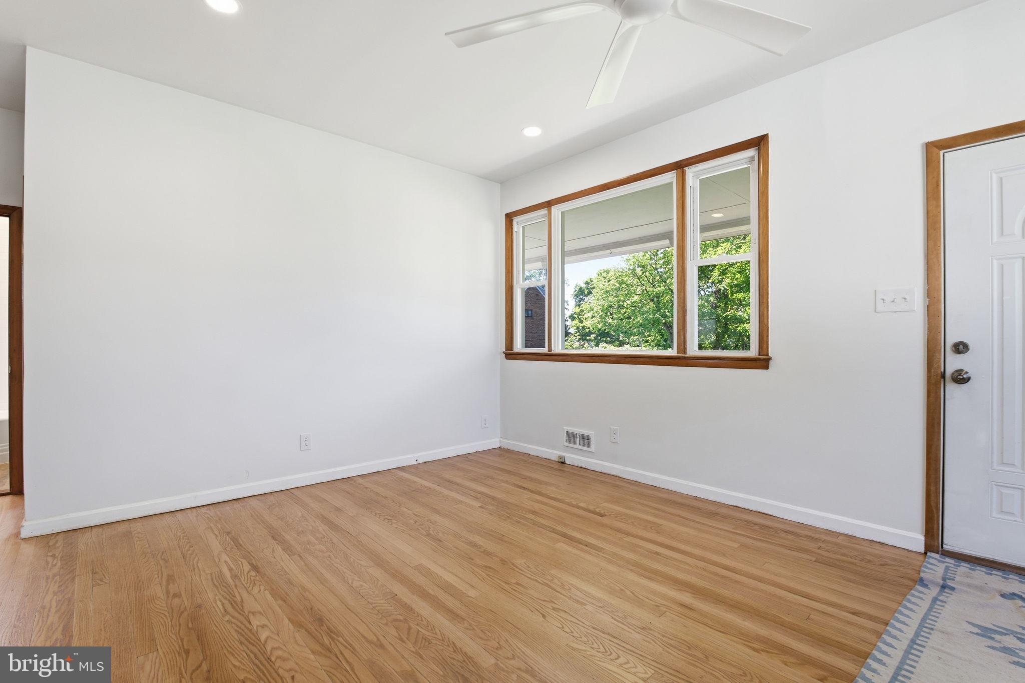 2301 Bayside Drive Baltimore, MD 21221 - Photo 14 of 35 an empty room with wooden floor and windows