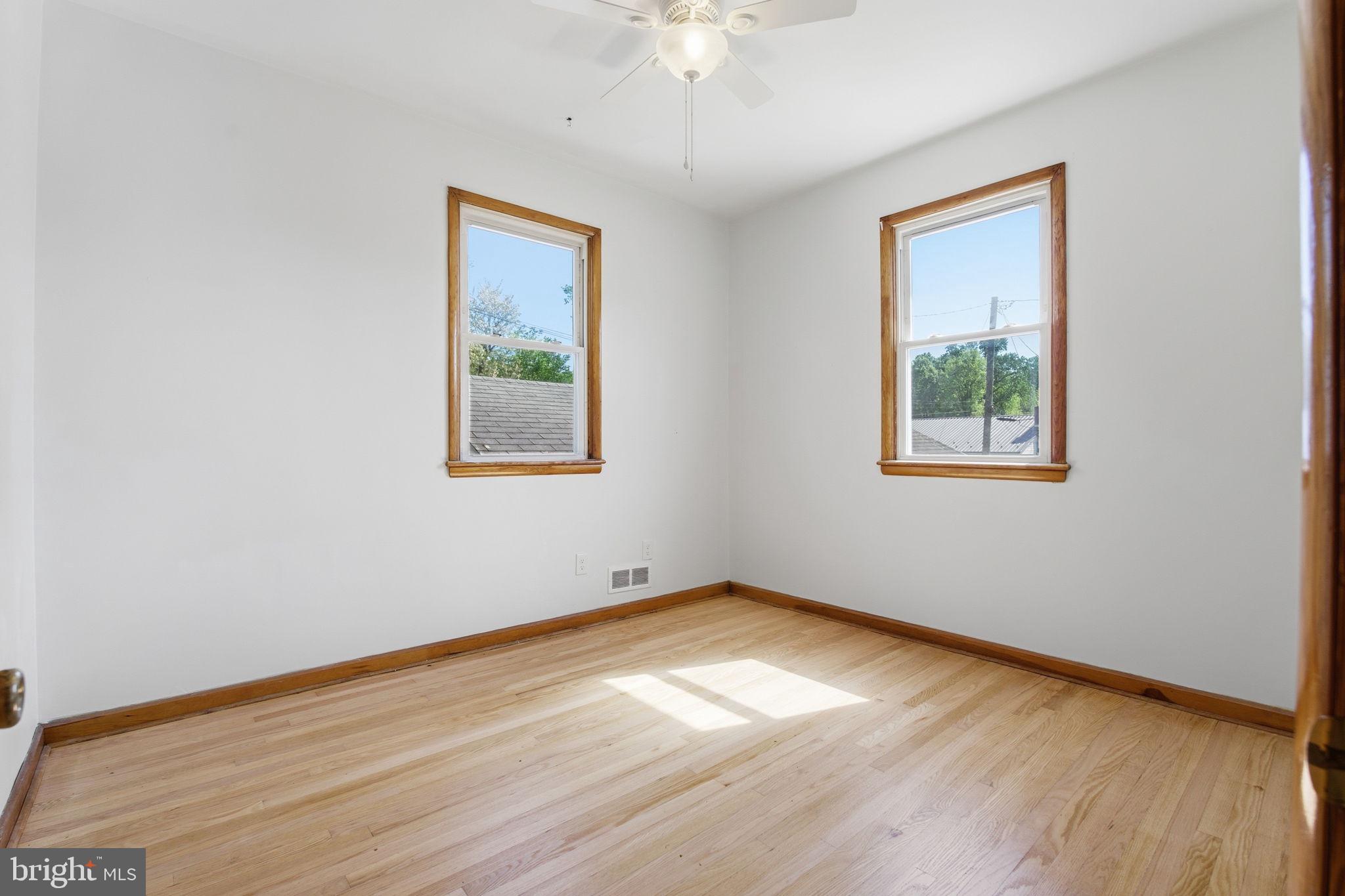 2301 Bayside Drive Baltimore, MD 21221 - Photo 15 of 35 a view of an empty room with wooden floor and a window