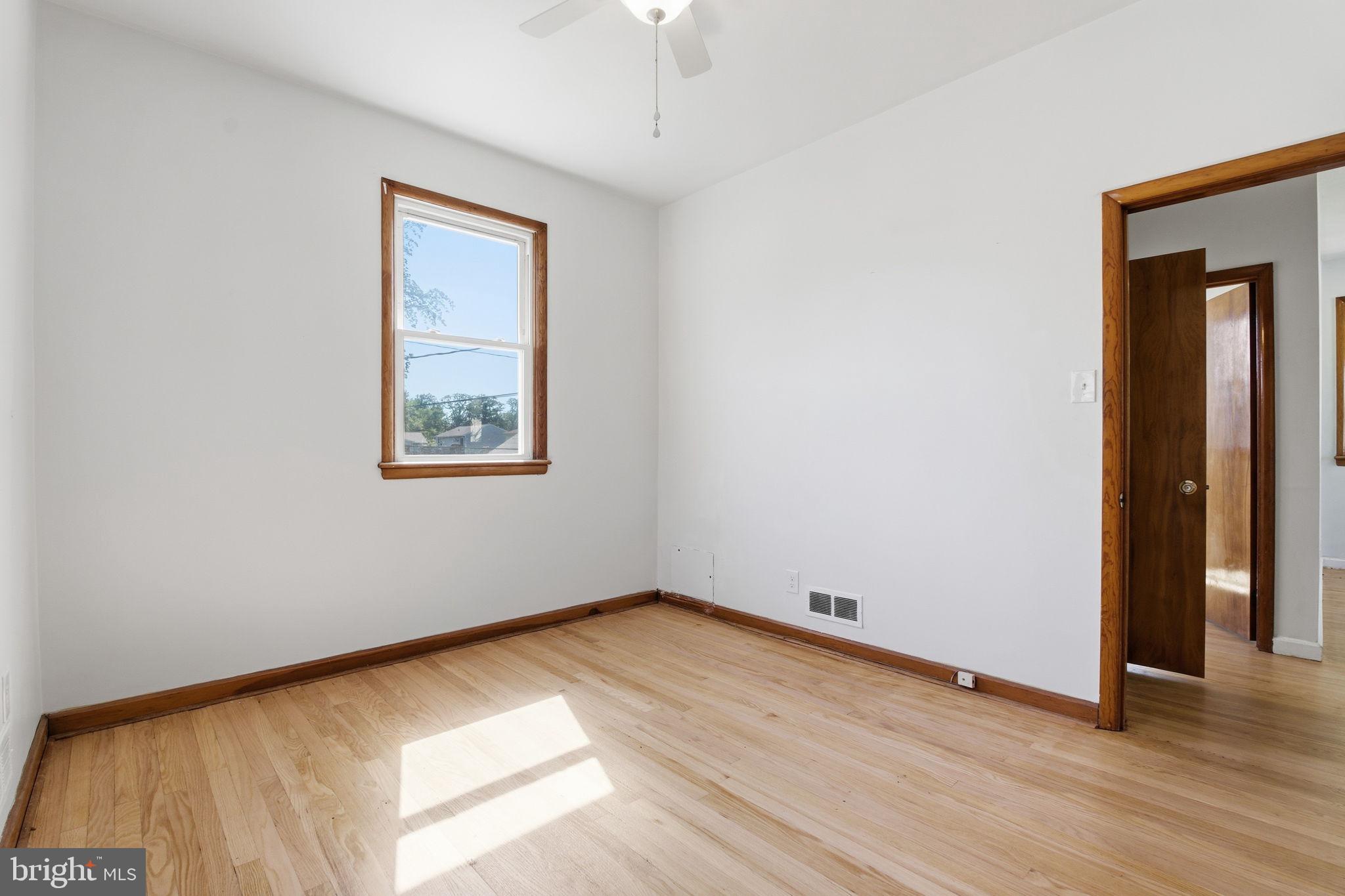 2301 Bayside Drive Baltimore, MD 21221 - Photo 16 of 35 an empty room with wooden floor and windows