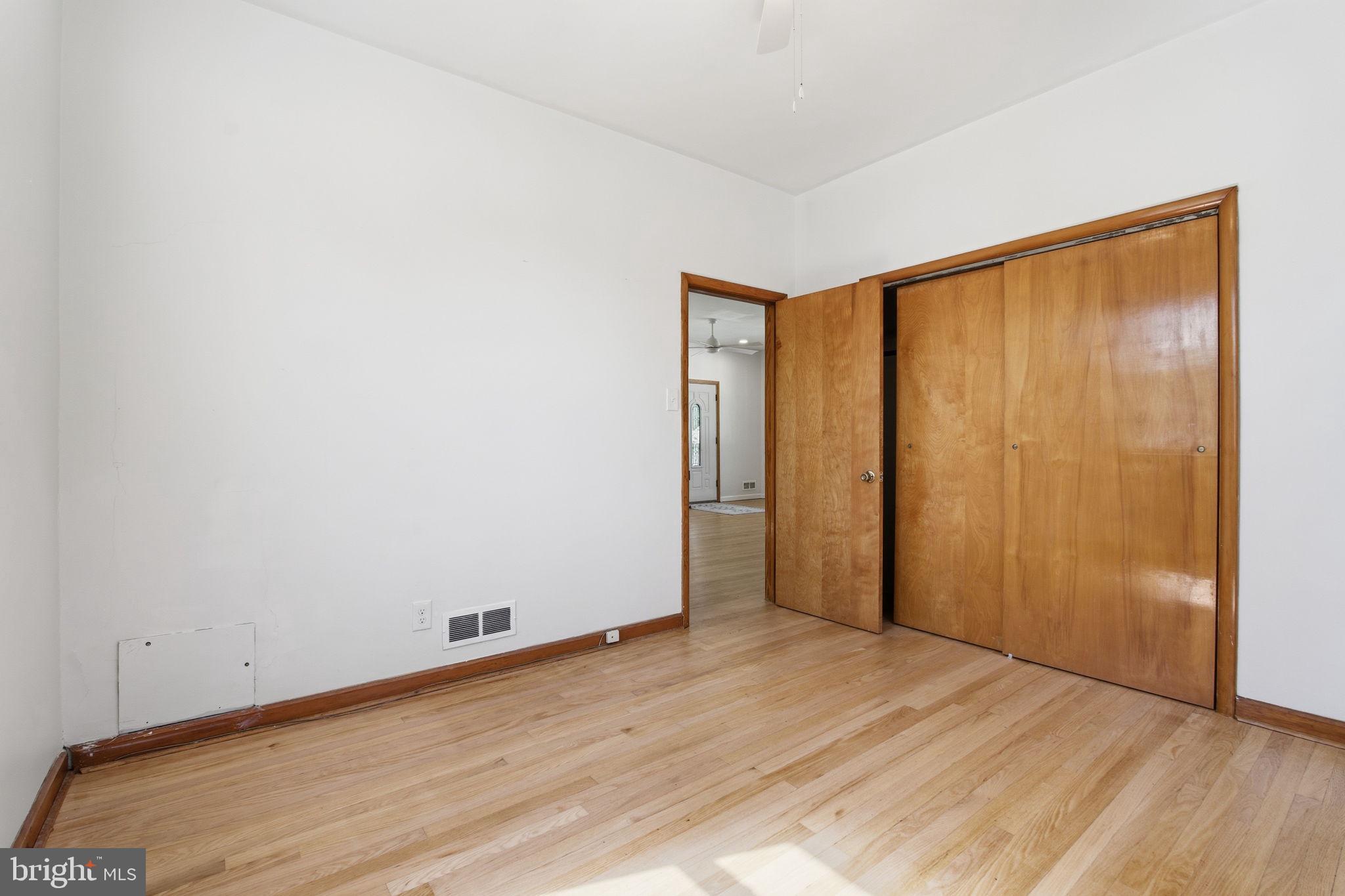 2301 Bayside Drive Baltimore, MD 21221 - Photo 17 of 35 an empty room with wooden floor and closet area
