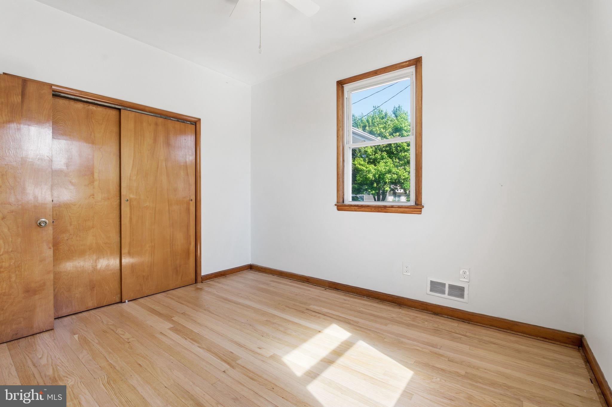 2301 Bayside Drive Baltimore, MD 21221 - Photo 18 of 35 a view of an empty room with wooden floor and a window