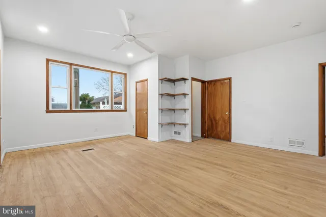 a big room with closet and windows