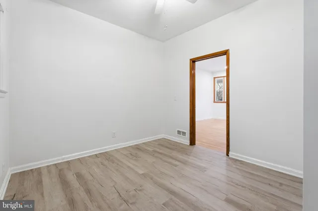 an empty room with wooden floor and closet