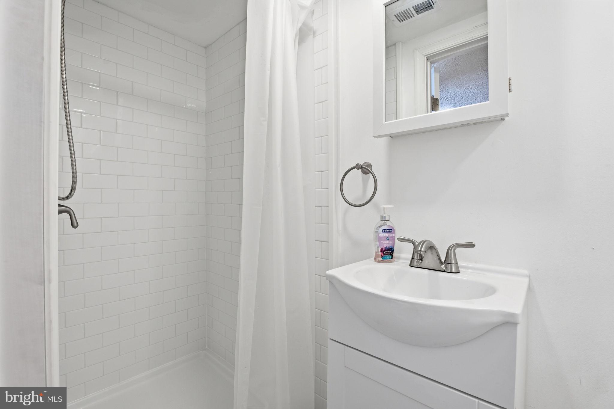 2301 Bayside Drive Baltimore, MD 21221 - Photo 30 of 35 a bathroom with a sink and a mirror