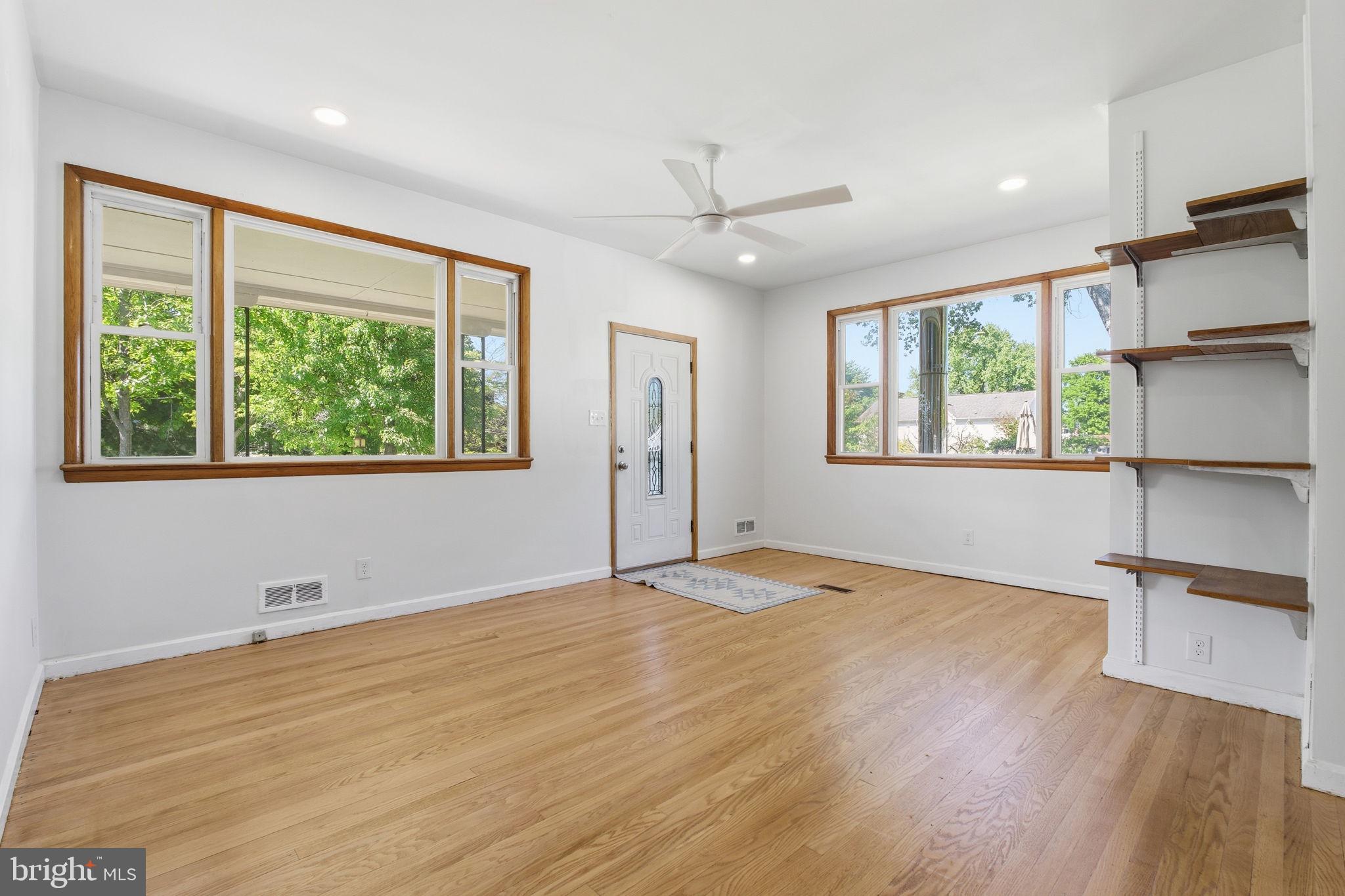2301 Bayside Drive Baltimore, MD 21221 - Photo 4 of 35 a view of an empty room with a window and wooden floor