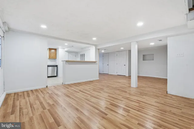 a view of empty room with wooden floor