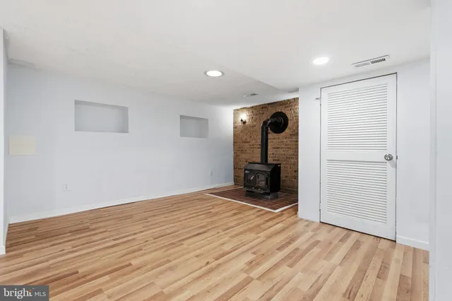 a view of a livingroom with a hall and wooden floor